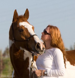 Photographer Kimerlee Curyl's flaming red hair is complemented by the copper tones of her mare, Sequoia.