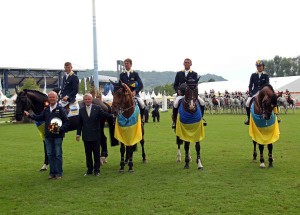 The Ukranian show jumpng team assembles waring victory blankets at a qualifying class for the 2012 Olympics.