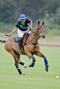 Karen Reese of Terry Ryken's Sotheby’s team swings her mallet astride a bay polo pony at the 2nd Annual WCT Qualifier at the Santa Barbara Polo Club.